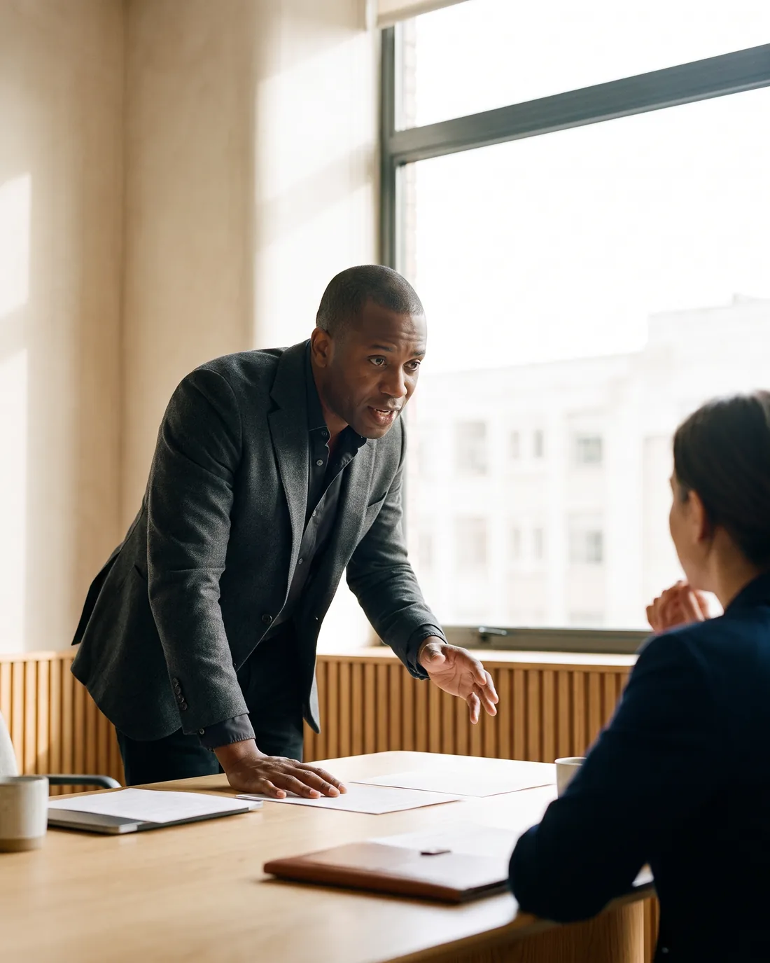 A senior CFO reviewing the work in a calm Amsterdam boardroom