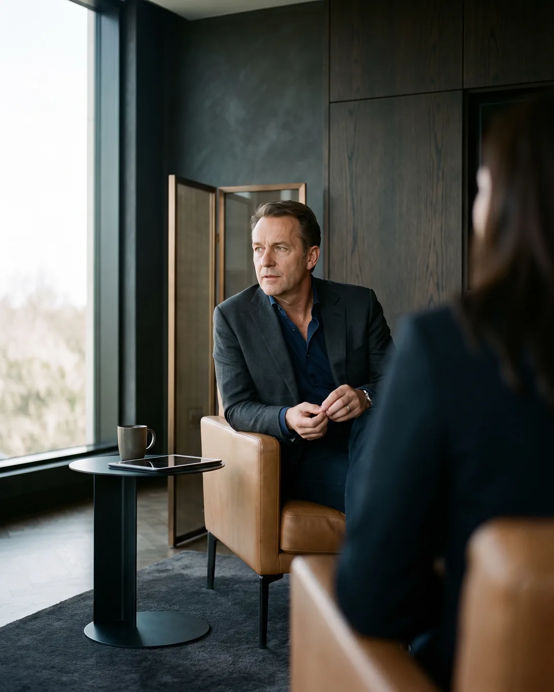 A senior CHRO reviewing the work in a calm Amsterdam boardroom