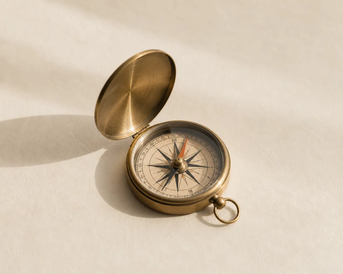 An open brass compass on warm paper — finding direction at a decisive moment