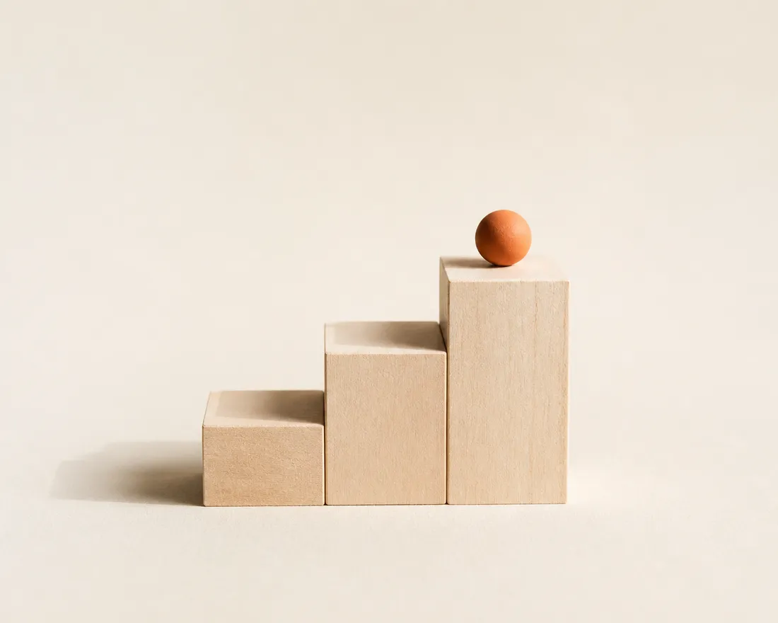 Pale wooden blocks rising like a staircase — a business growing through its stages